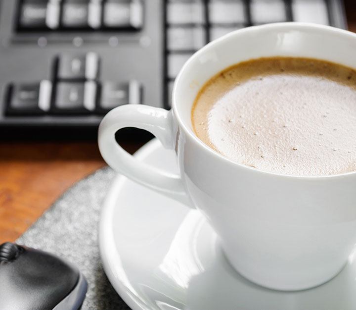 Cup of hot coffee on an office desk